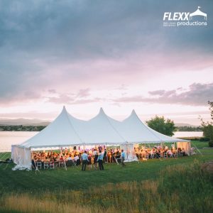 Large lakeside wedding reception held under a 40x80 pole tent rental