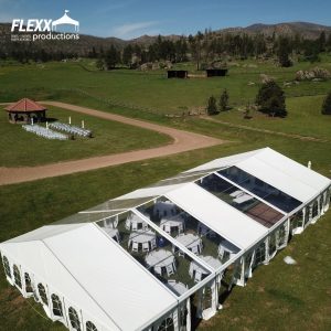 Large clearspan tent rental set up outdoors for a beautiful mountainside wedding and reception