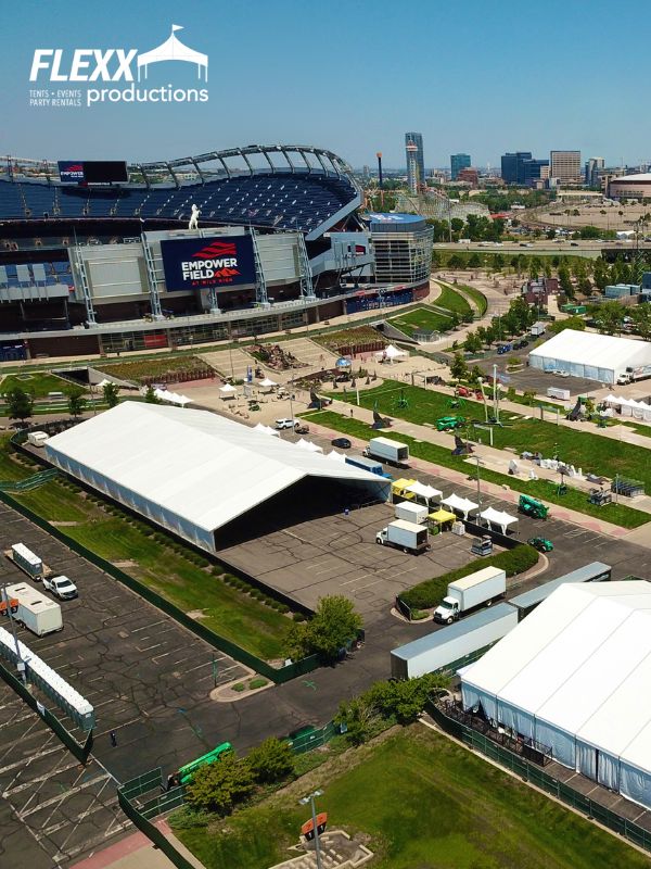 flexx-productions-large-tent-rentals Different size tent rentals set up in a parking lot surrounding Empower Stadium for an outdoor event in Denver, CO