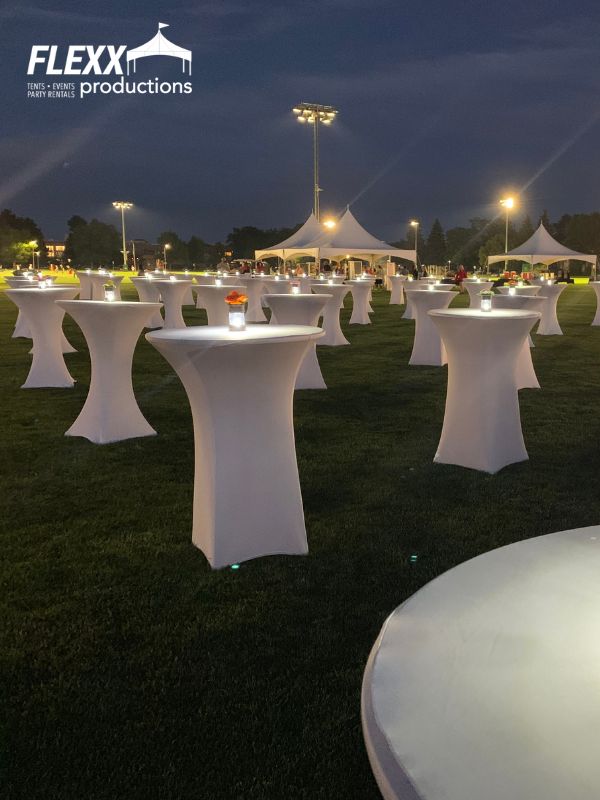 tables-and-tent-rentals-csu Tables with candles and tent rentals set up for an evening outdoor event