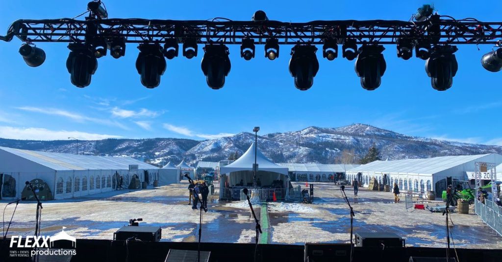 View from a stage with lightingin front of tent rentals set up in the mountains for an outdoor event