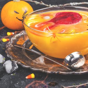 Punch bowl filled with orange and red punch for a Halloween party