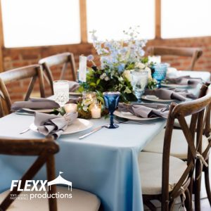 Napa wood table and chairs set with linen table cloth, china, glassware, flatware, and other party rentals