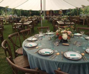 Wedding rentals like Napa wood tables, colored linen tablecloths, and dishware
