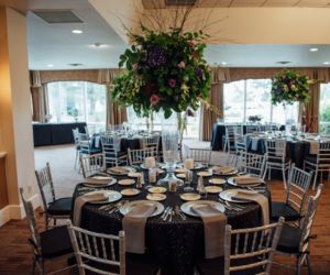 Wedding linen rentals in various dark and light colors placed on round tables
