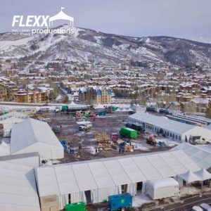 Multiple tent rentals set up outside for a snowy mountainside event