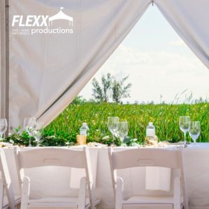 Opened tent walls in a party tent set up for a wedding