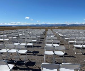 Chair rentals set up for a corporate event under a large structure tent