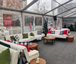 Furniture and decor rentals set up under a tent for a Christmas event