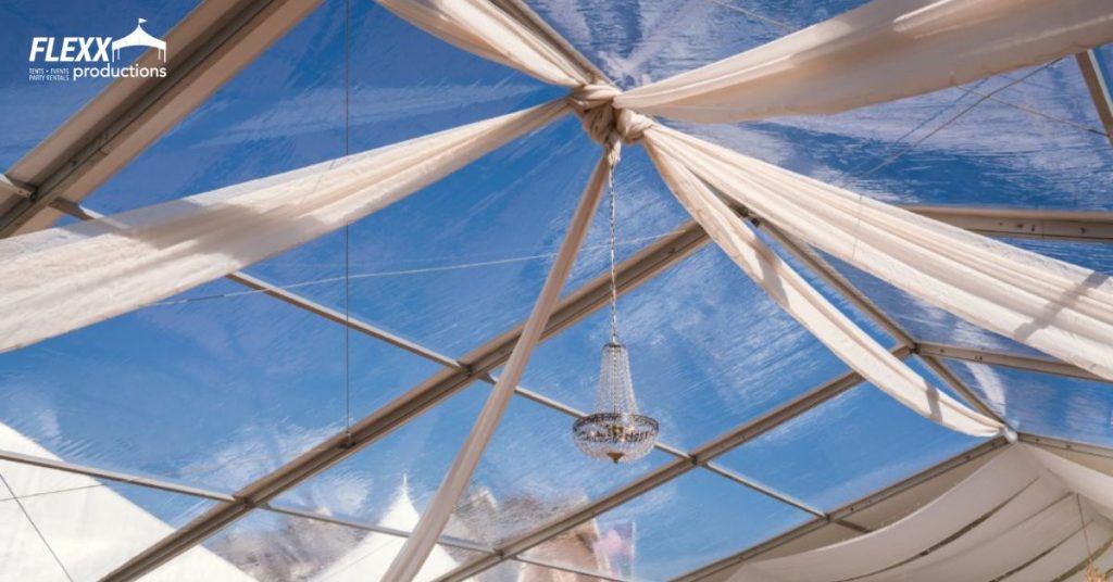Drapes and a chandelier accent in a wedding tent