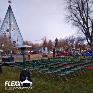 Chairs and outdoor heaters set up for an outdoor Christmas event