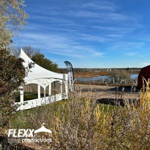 Tent rental set up outdoors near ponds for a nonprofit event