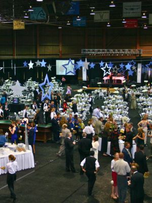 event-rentals-for-nonprofit-events People mingling at a nonprofit event with table and chair rentals