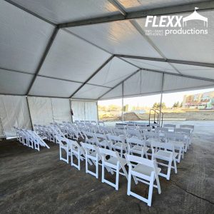 View from underneath a clearspan tent with an open front and chairs set up 