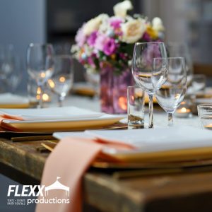 Beautiful holiday table setting with white china, gold chargers, linens, and three types of glassware