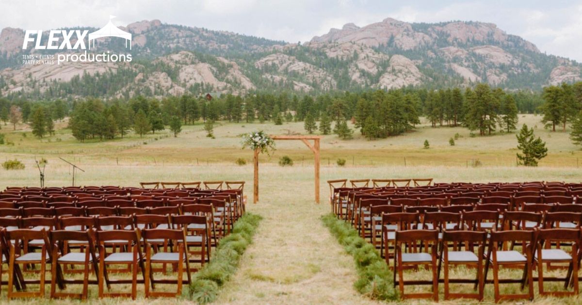 Mountainside backyard wedding with wedding rentals like chairs and decorated archway
