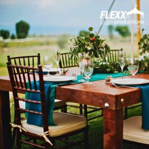 Beautiful table setting for an outdoor wedding set up under a tent