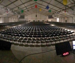 Chair rentals set up under a structure tent