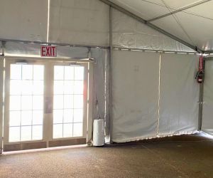 Exit sign and fire extinguisher installed on a tent's interior