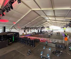 Lighting being installed for an event underneath a structure tent
