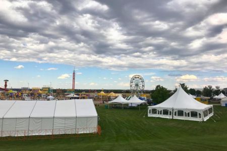 tent-rentals Several types of tent rentals set up at a fair