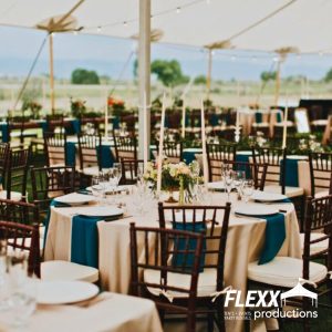 Tables, chairs, and other party rentals set up under a Tidewater tent