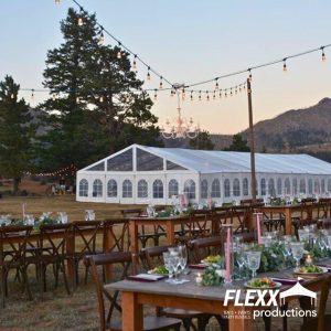 Large Clearspan tent with asp ends, windows, and doors set up for an outdoor wedding